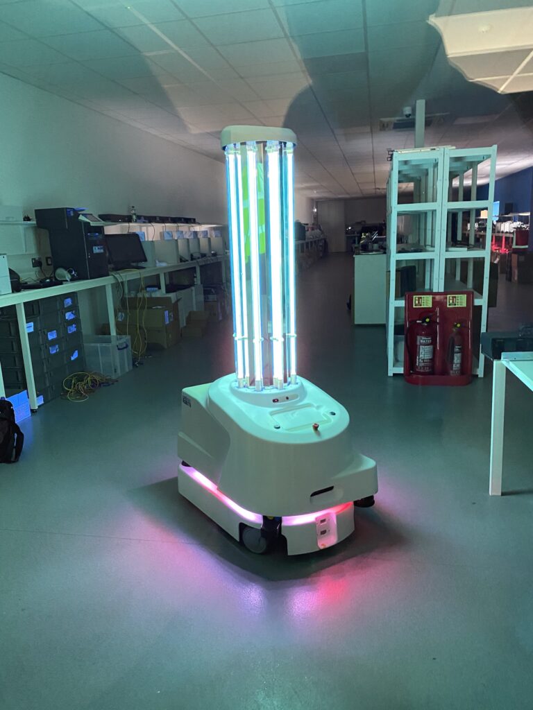UVD Robot in Warehouse with its UVC lights on